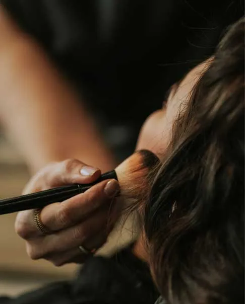 Makeup artist applying makeup to a client at Olaya & Co. in Byron Bay