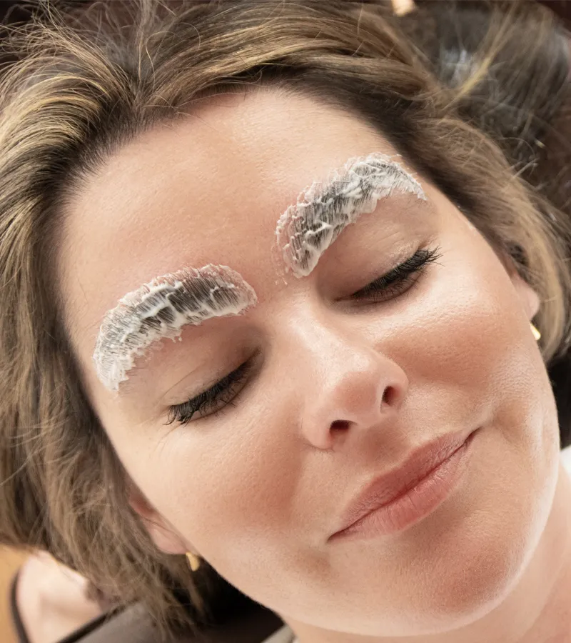 Brushing the brows upward with a spoolie to set their shape