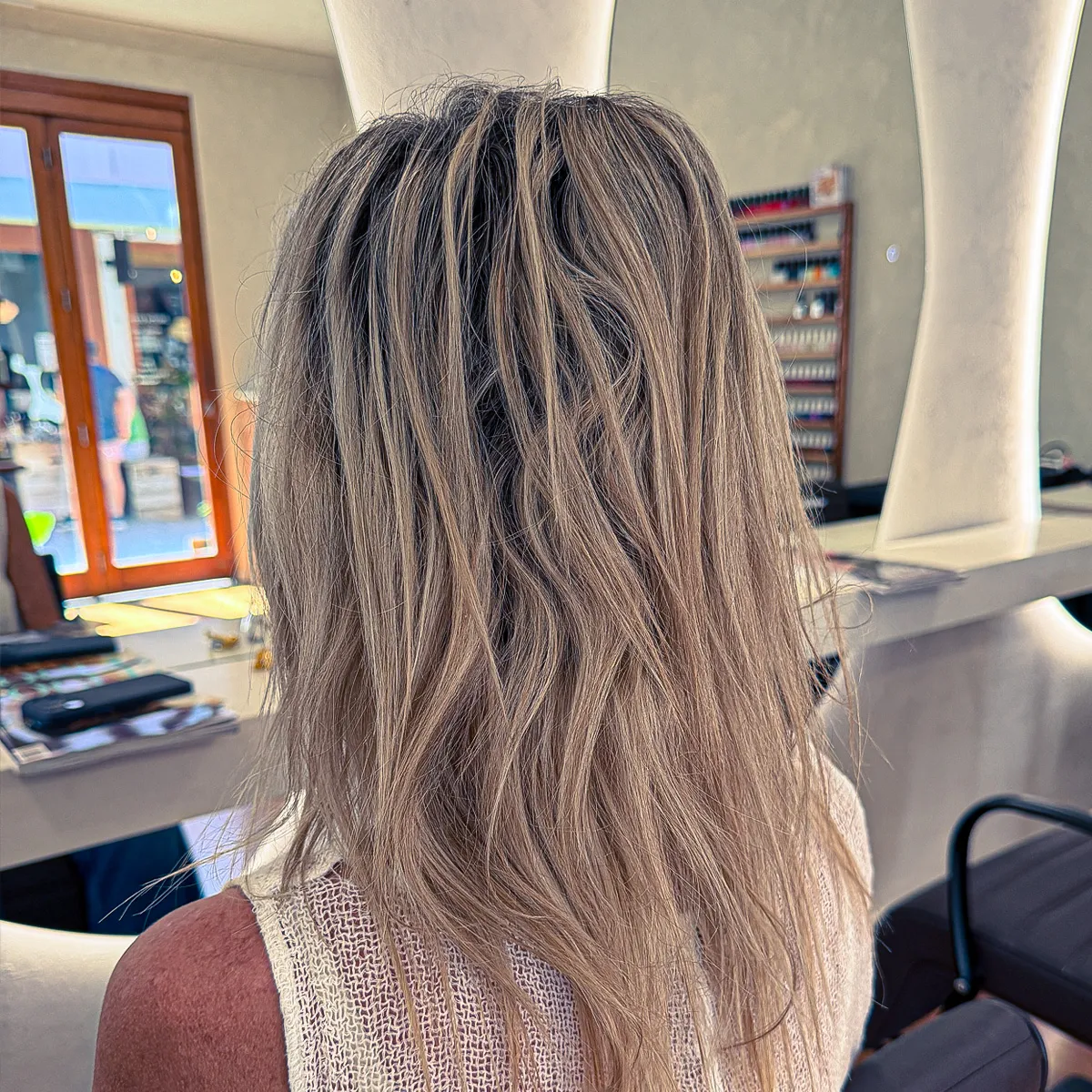 Smooth, frizz-free ash blonde hair with a glossy finish following a nanoplasty treatment — before