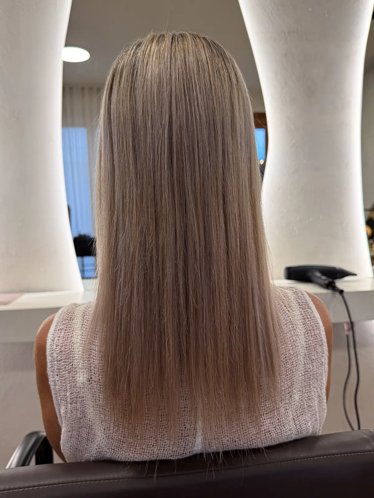 Long, sleek straight hair after a nanoplasty smoothing treatment