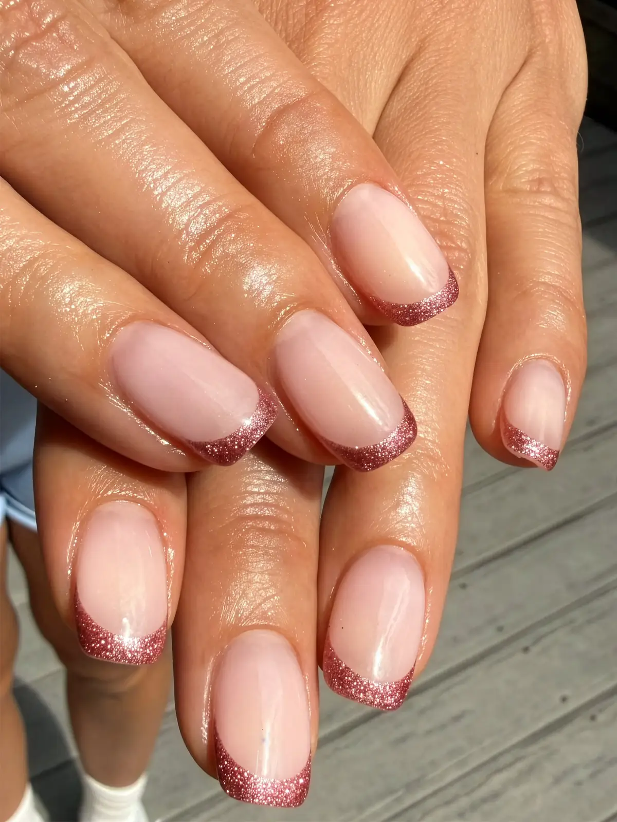 Nude nails with rose-pink glitter French tips