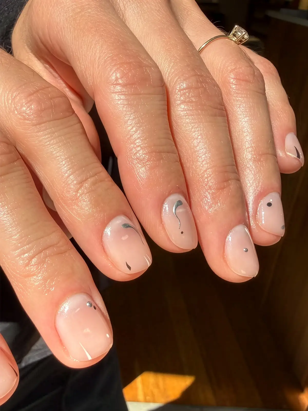 Short nude nails with minimalist abstract dots and fine grey strokes