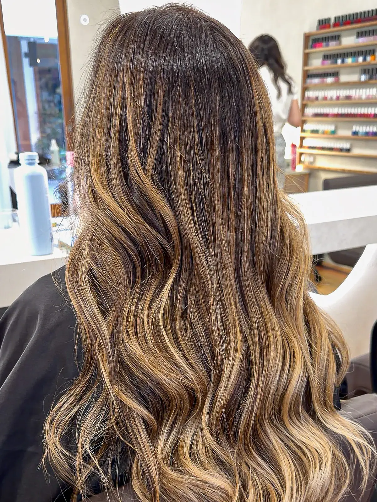 Long brunette hair with caramel highlights in loose waves