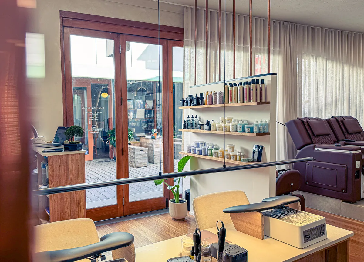 Interior of the Olaya & Co. salon in Byron Bay, with manicure tables, product shelves and pedicure chairs